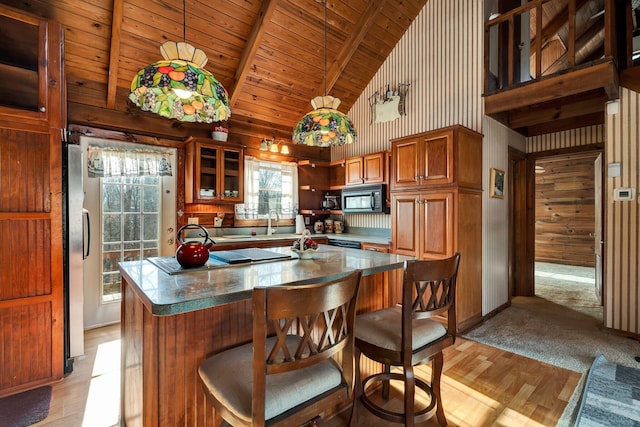 kitchen featuring pendant lighting, beam ceiling, wood ceiling, high vaulted ceiling, and black appliances