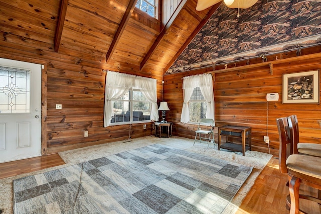 living room with hardwood / wood-style flooring, wooden ceiling, high vaulted ceiling, and beam ceiling