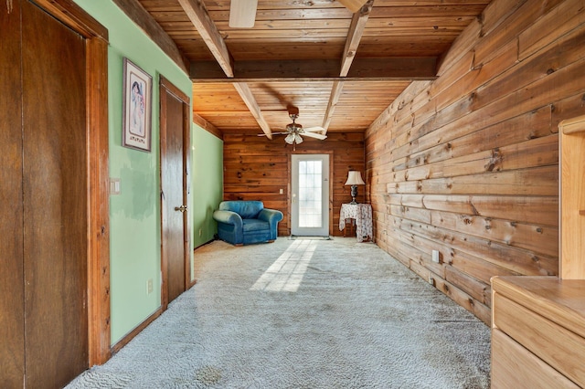 unfurnished room with carpet floors, wooden ceiling, wood walls, and beamed ceiling