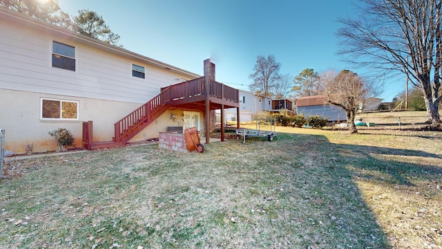 view of jungle gym with a lawn and a deck