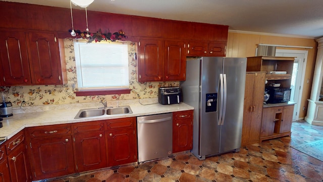 kitchen with sink, stainless steel appliances, and ornamental molding