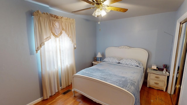 bedroom featuring ceiling fan and hardwood / wood-style flooring