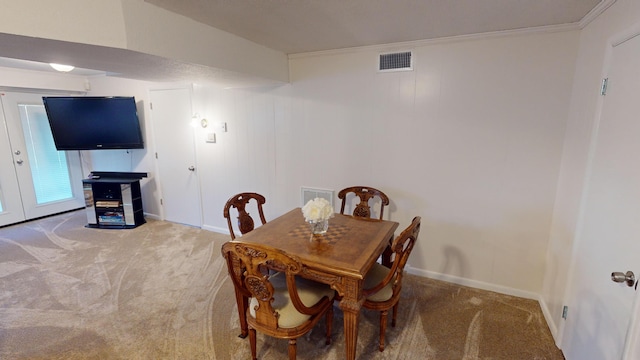 dining room with carpet and crown molding