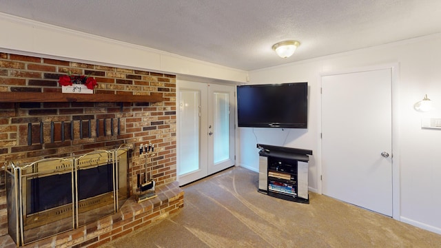 living room featuring a brick fireplace, ornamental molding, french doors, a textured ceiling, and carpet flooring