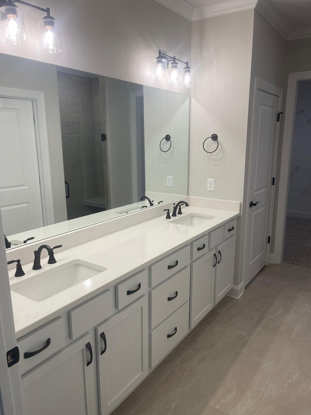 bathroom with a shower with shower door, vanity, tile patterned flooring, and ornamental molding