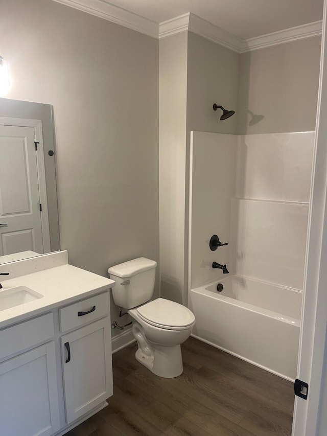 full bathroom featuring hardwood / wood-style floors, shower / tub combination, vanity, toilet, and crown molding