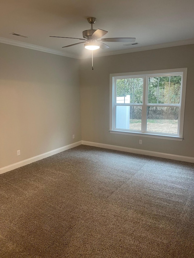 carpeted spare room featuring ceiling fan and crown molding