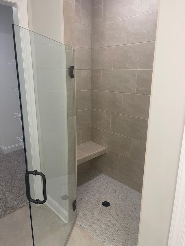 bathroom with tile patterned floors and walk in shower