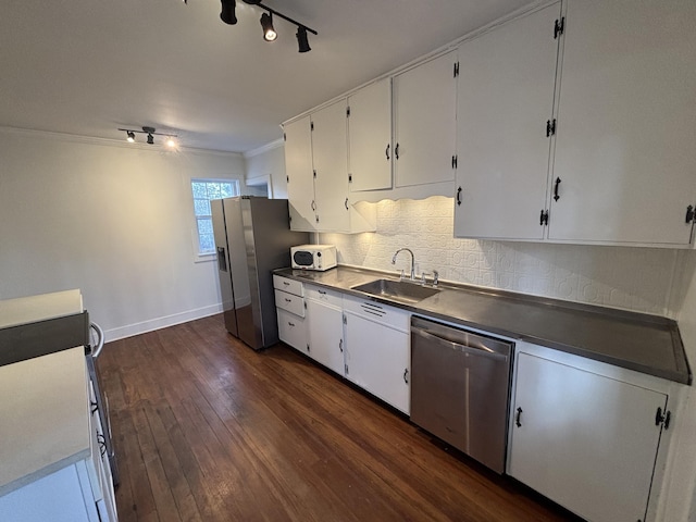 kitchen with white cabinetry, stainless steel appliances, dark hardwood / wood-style floors, crown molding, and sink