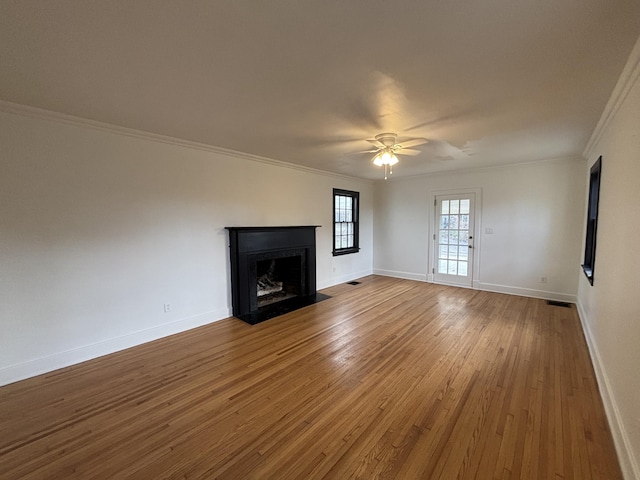 unfurnished living room featuring ceiling fan, crown molding, and hardwood / wood-style flooring