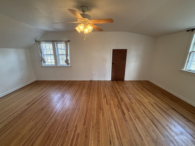 additional living space featuring ceiling fan, vaulted ceiling, and light hardwood / wood-style floors