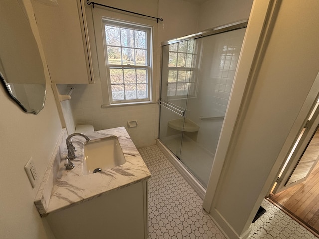 bathroom featuring vanity, tile patterned flooring, and walk in shower