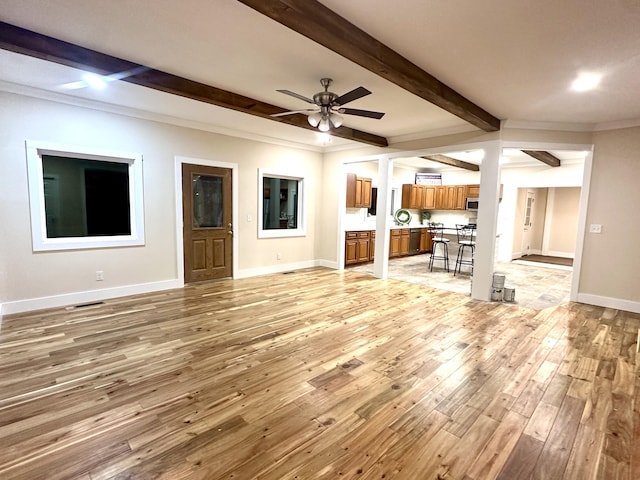 unfurnished living room with ceiling fan, crown molding, light hardwood / wood-style flooring, and beamed ceiling