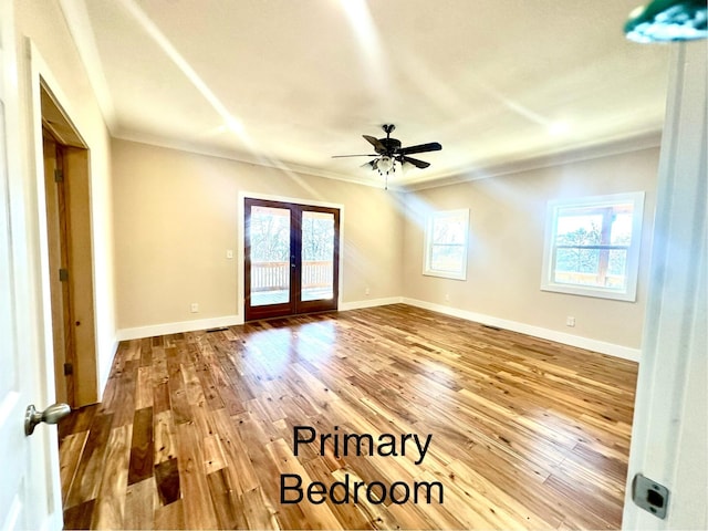 unfurnished room with hardwood / wood-style floors, ceiling fan, ornamental molding, and french doors