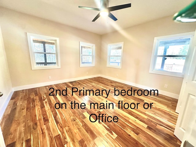 unfurnished room with ceiling fan and wood-type flooring