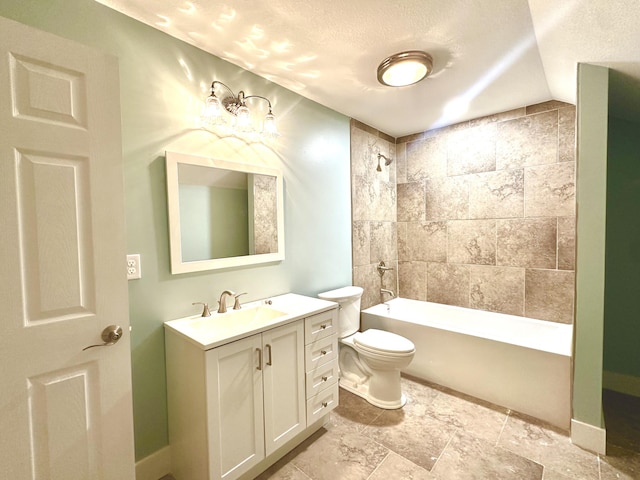 full bathroom with a textured ceiling, toilet, vanity, and tiled shower / bath combo