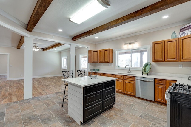 kitchen featuring sink, a breakfast bar area, beam ceiling, stainless steel appliances, and a center island