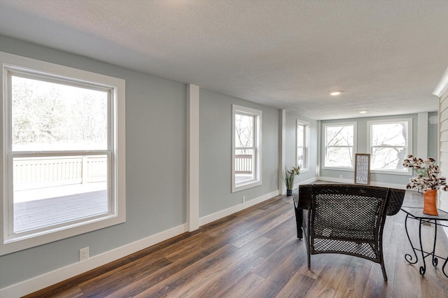 office area featuring dark wood-type flooring and a textured ceiling