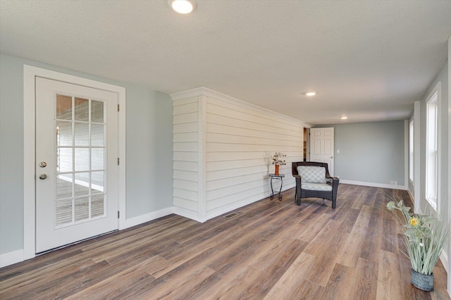 unfurnished room with wood-type flooring and a textured ceiling