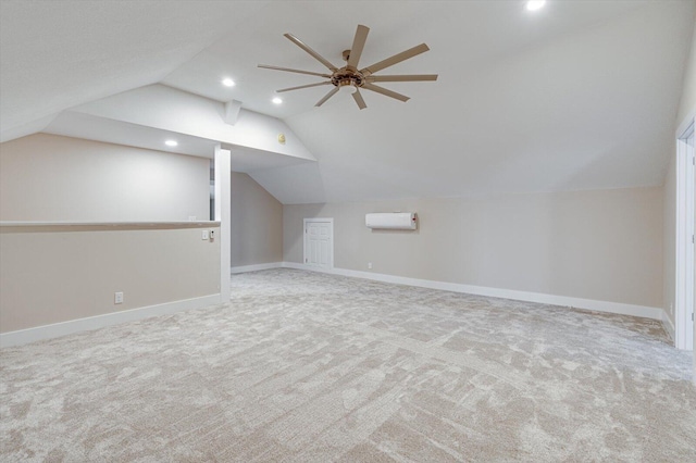 bonus room featuring lofted ceiling, light colored carpet, a wall unit AC, and ceiling fan