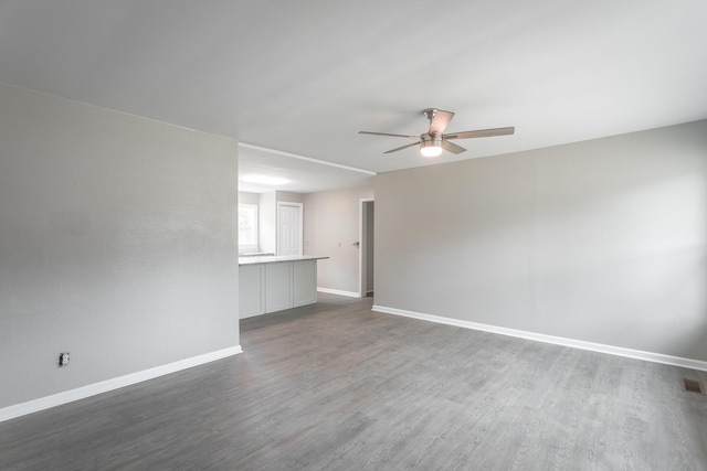 unfurnished room with ceiling fan and dark hardwood / wood-style flooring