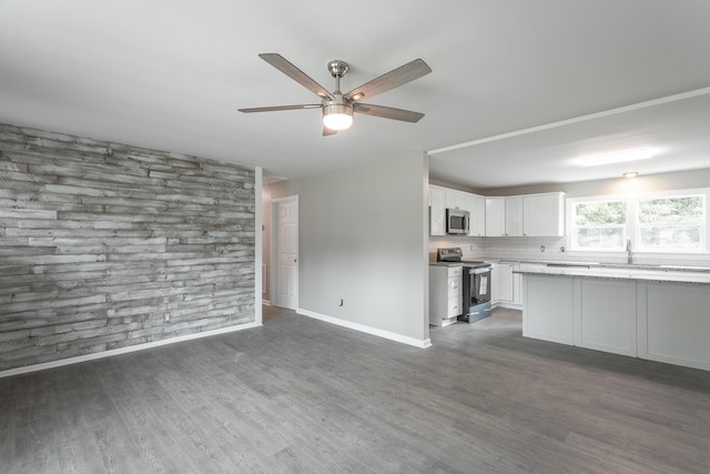 kitchen featuring dark hardwood / wood-style floors, white cabinetry, sink, decorative backsplash, and stainless steel appliances