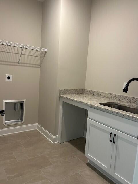 laundry room featuring sink, light tile patterned floors, and electric dryer hookup