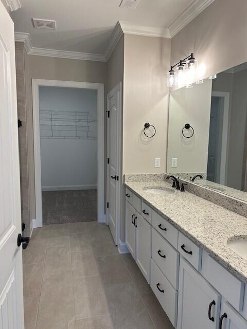 bathroom featuring ornamental molding, tile patterned floors, and vanity