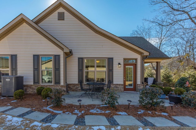 view of front of property featuring central AC unit and a patio area