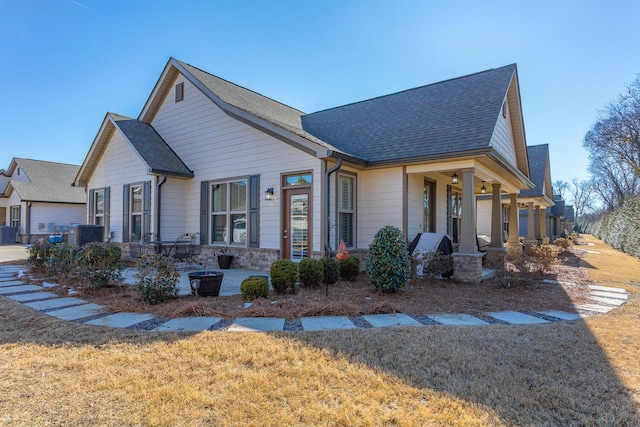 view of front of home featuring a front lawn and cooling unit