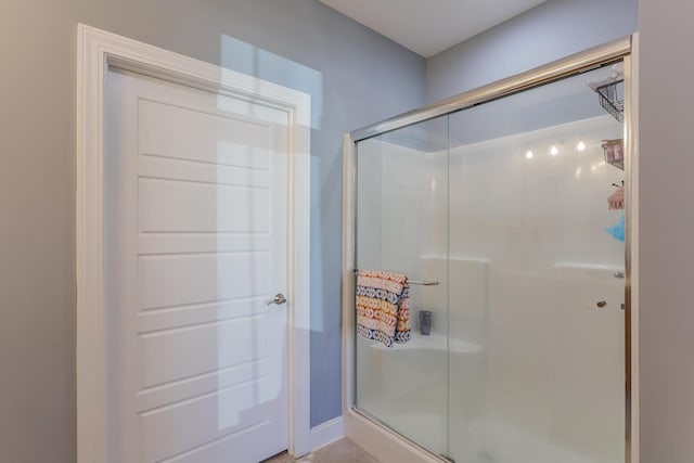 bathroom with a shower with shower door