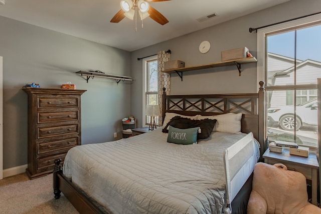 bedroom with ceiling fan and light colored carpet