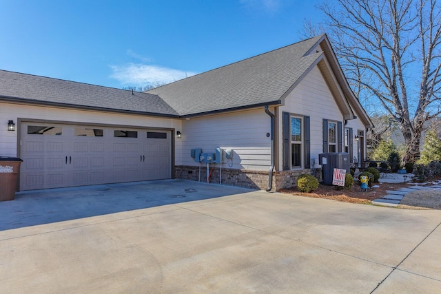 view of home's exterior with a garage and cooling unit