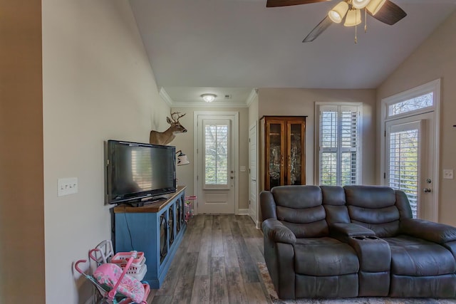 living room with ceiling fan, vaulted ceiling, and dark wood-type flooring