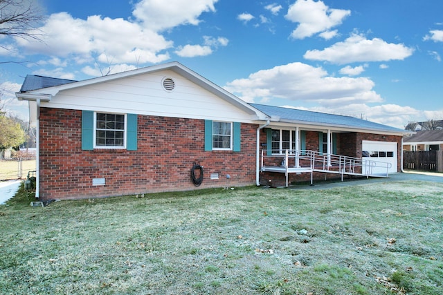 ranch-style home featuring a garage, a front yard, and covered porch