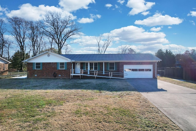 single story home featuring a garage, a front yard, and covered porch