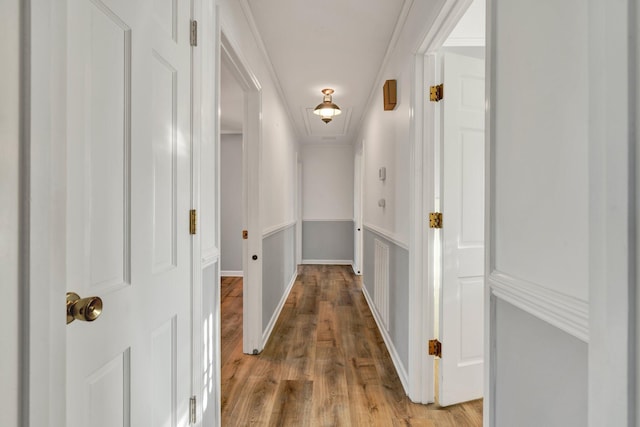 hall featuring light hardwood / wood-style floors and ornamental molding