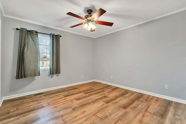 spare room with ceiling fan, ornamental molding, and wood-type flooring