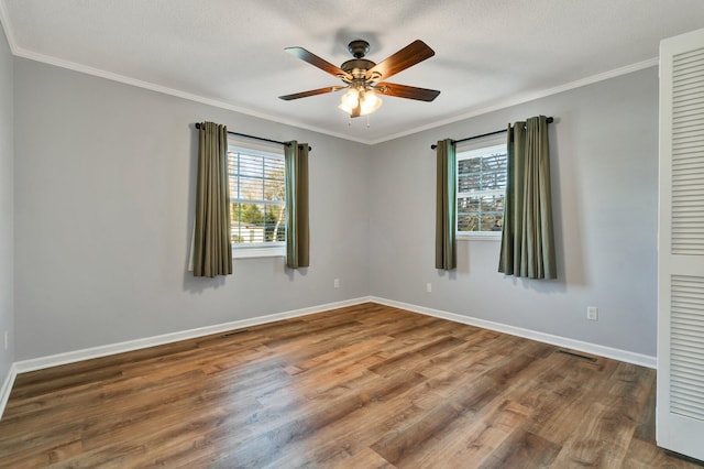 unfurnished room featuring a textured ceiling, ceiling fan, ornamental molding, and wood-type flooring