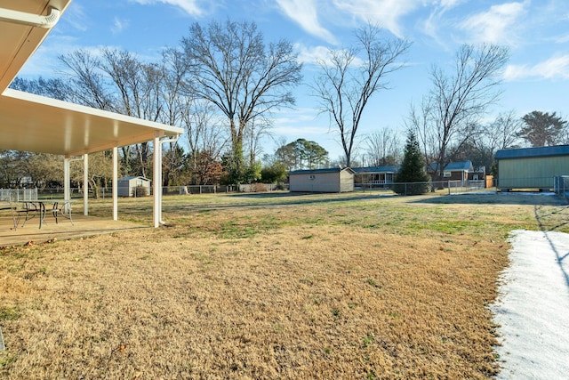 view of yard featuring a deck and a shed