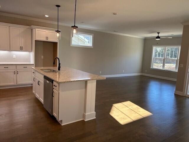 kitchen with white cabinetry, dishwasher, light stone counters, and sink