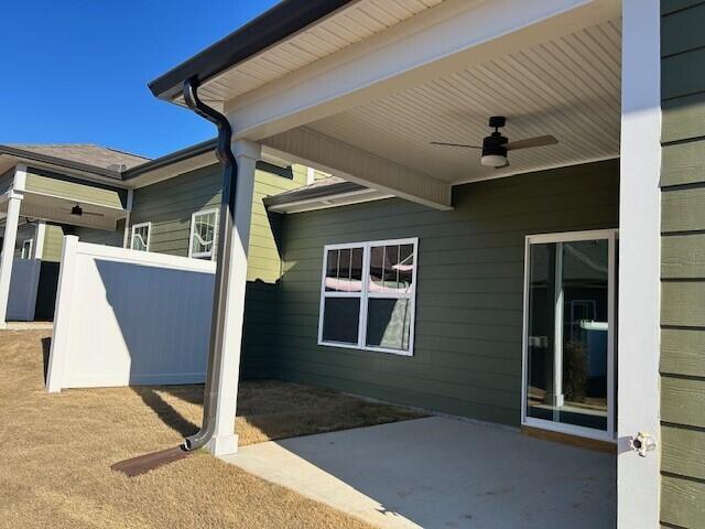 exterior space with ceiling fan