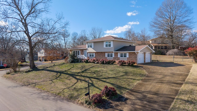 view of front of property featuring a garage and a front yard