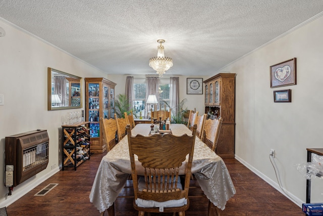 dining room featuring a textured ceiling, dark hardwood / wood-style flooring, ornamental molding, a chandelier, and heating unit