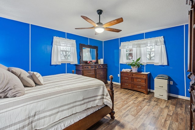 bedroom featuring ceiling fan and wood-type flooring