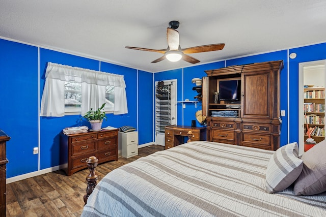 bedroom featuring ceiling fan and dark hardwood / wood-style floors