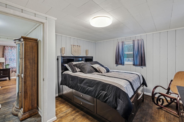 bedroom featuring dark hardwood / wood-style flooring and crown molding