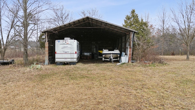 view of outbuilding with a carport and a lawn