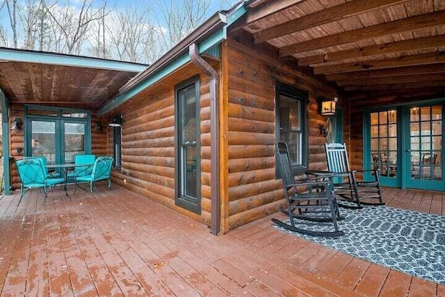 exterior space with a wooden deck and french doors