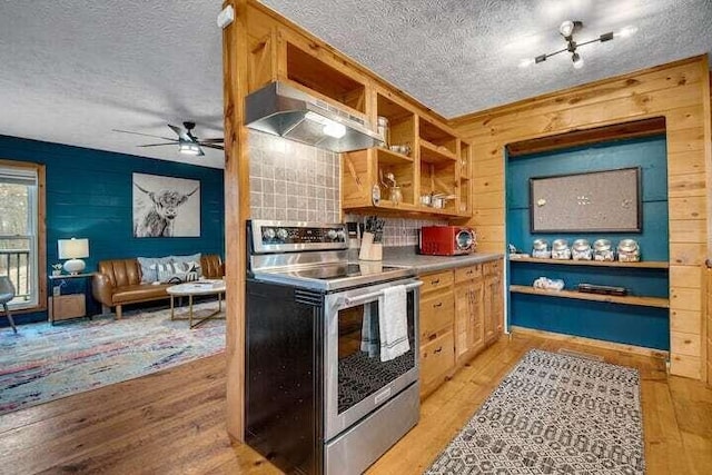 kitchen featuring electric range, ventilation hood, and light hardwood / wood-style floors